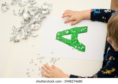 Two Year Boy Decorating Play Dough Letter 