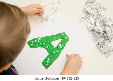 Two Year Boy Decorating Play Dough Letter 