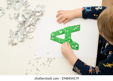 Two Year Boy Decorating Play Dough Letter 