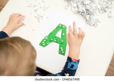 Two Year Boy Decorating Play Dough Letter 