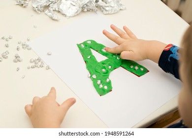 Two Year Boy Decorating Play Dough Letter 