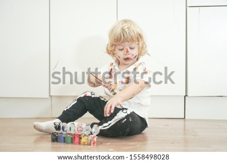 Similar – Baby girl playing with hair clips sitting in the floor