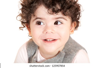 Two year old girl with curly hair portrait, studio shot.
