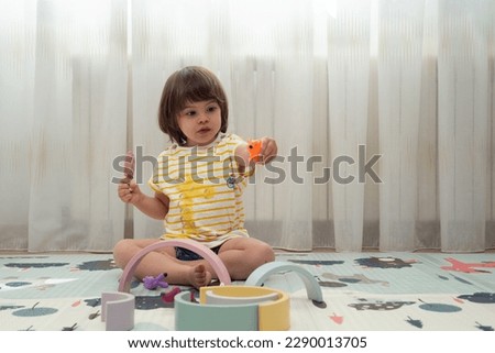 Similar – Baby girl playing with hair clips sitting in the floor