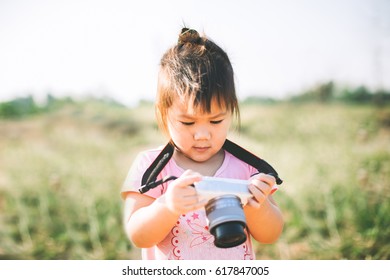 Two Years Old Kid Try To Use A Camera As A Photographer. Concept Picture For Shutterstock.