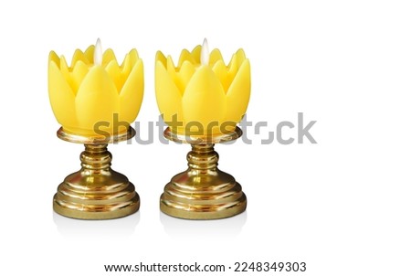 two yellow candles placed on gold pedestal on white background, object, decor, retro, religion, copy space