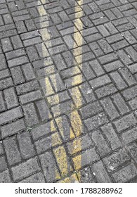 Two Yellow Lines On The Paving Floor During The Day. Good For Backgrounds And More.