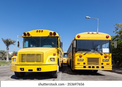 Two yellow school buses at the school parking lot