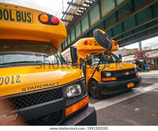 Two Yellow School\
buses wait for children near to subway 238st, Bronx, New York,\
United States. 5.27.2021