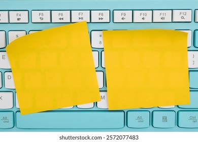 Two yellow sticky notes placed on a computer keyboard. Perfect for reminders, office work, or creative note-taking.