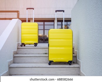 Two Yellow suitcases on the steps in the hotel. Baggage on the stairs