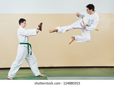 Two Young Adult People In Kimono Training Taekwondo Martial Art At Gym