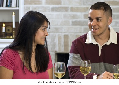 Two young adults enjoying a glass of wine together.
