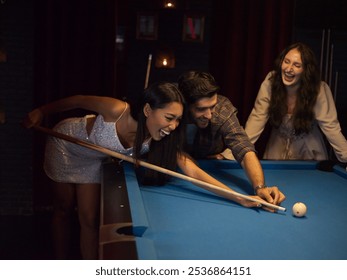 Two young adults a man and a woman engaged in a game of pool on a blue pool table in a dimly lit cozy bar or lounge setting  - Powered by Shutterstock