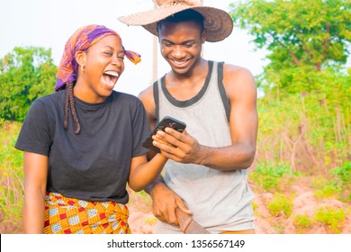 two young African farmers using their smartphone excited - Powered by Shutterstock