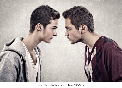 Two young angry people standing face to face