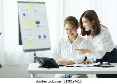 Two young asia business woman working together in office space - Shutterstock ID 2138194615