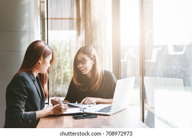 Two Young Asia Business Woman Working Together In Office Space