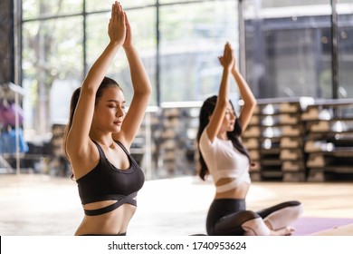 Two Young Asian athlete practicing yoga class, healthy or Meditation Exercise,stretching in upward facing dog exercise, wearing sportswear bra and pants, sports and healthcare concept,