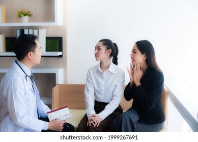 Two Young Asian Beautiful Woman Is Consulting With A Surgeon In A Cosmetic Clinic To Perform Cosmetic Surgery. Surgical Surgery By A Specialist Doctor