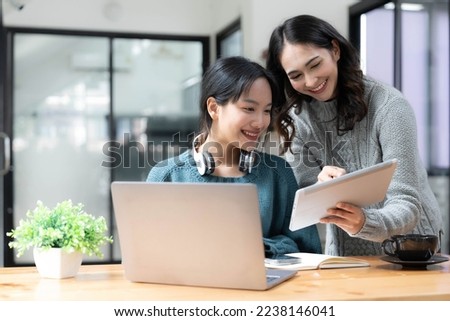 Two young Asian businesswoman discuss financial management planning. new startup project ideas analysis of financial planning and statistics and the investment market at the office