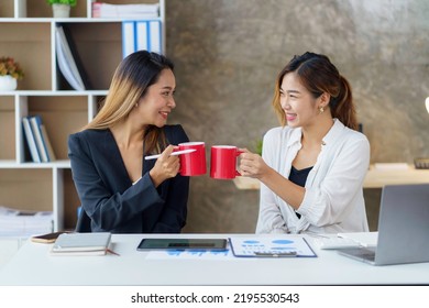 Two Young Asian Businesswomen Join Together For Coffee And Work Discussion And Share Their Job Descriptions And Job Description In Making New Product For The Company.