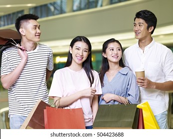 Two Young Asian Couples People Shopping In A Modern Mall