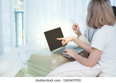 Two Young Asian Girls Preparing For Travel Vacation By Use Laptop And Tablet And Paid By Credit Card For Booking Tour.online Booking Or Online Commercial Concept.