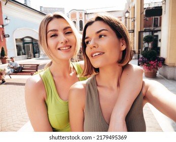 Two young beautiful smiling hipster girls in trendy summer clothes.Sexy  carefree women posing on the street background in sunglasses. Positive  models having fun and hugging.They going crazy Stock Photo