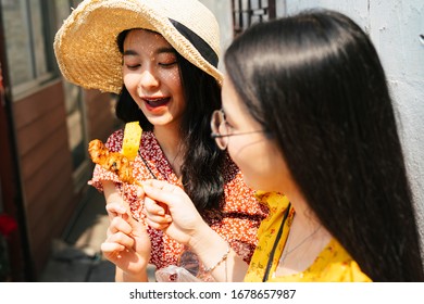 Two Young Beautiful Thai Asian Traveler Women Bestfriend Enjoy Eating Street Food In Thailand Together.