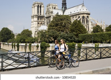 Two Young Beautiful Woman Are Visiting Paris In Summer With Bicycle