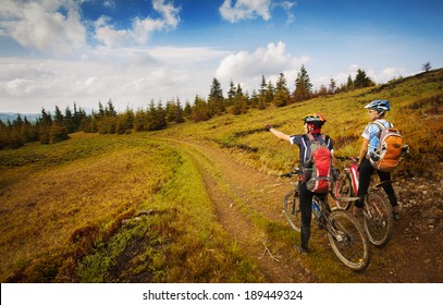 Two young bikers looking at the mountains - Powered by Shutterstock