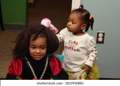 Two Young Black Girls Playing Beauty Salon