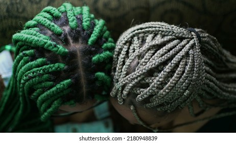 Two young black latina women with box braids hairstyle looking at camera. Braided cool hair style fashion portrait