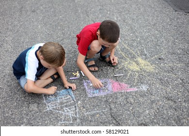 two young boys drawing and sidewalk chalk    family   kids