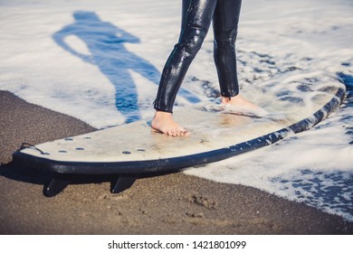Two young boys having a beginner surf lesson and having fun in a sunny day in summer