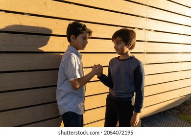 Two Young Boys Shaking Hands. South Asian Kids Bonding. Diversity Friendship Concept. Children Doing Handshake. Casual Conversation.