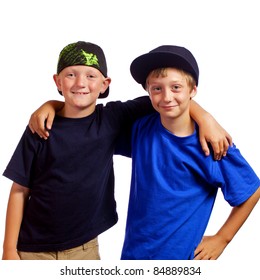 Two Young Boys Who Are Friends With Each Other Standing With Their Arms Around Each Other Smiling.