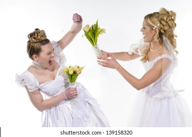 Two Young Brides In White Wedding Dresses Fight Against Each Other And Beat With Flowers