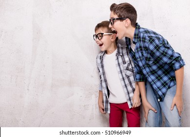 Two Young Brothers Having Fun Together, Smiling. Studio Shot.