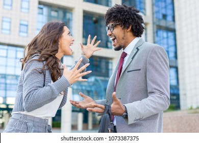 Two Young Business People Yelling At Each Other In Front Of The Office