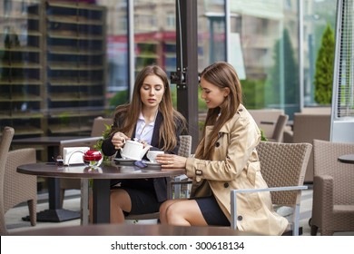 Two Young Business Women Having Lunch Break Together In A Coffee Shop