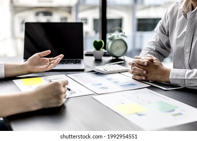 Two Young Businessmen Discuss Issues And Solutions Together, They Are Business Partners Forming A Start-up Company, Managing The Company For Growth And Stability. Start-up Company Management Concept.