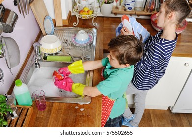 Two young caucasian children are doing the dishes in kitchen at home - Powered by Shutterstock