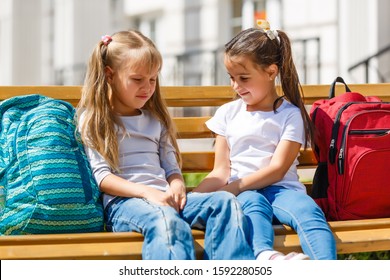 Two young children sitting at the top of playground equipment - Shutterstock ID 1592280505