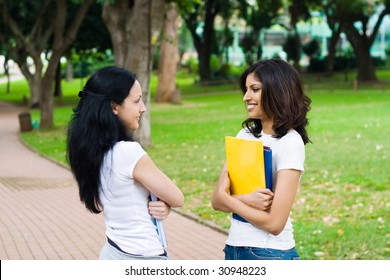 Two Young College Students Talking In School Campus