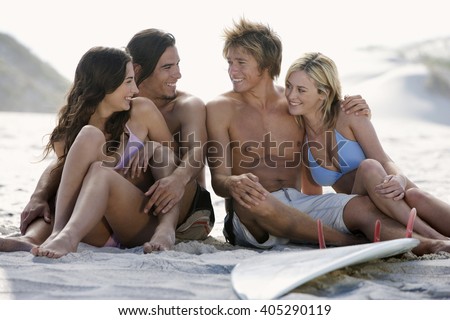 Two young couples on a beach