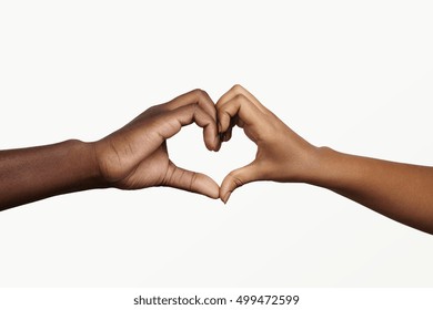 Two Young Dark-skinned People Holding Hands In Shape Of Heart, Symbolizing Love, Peace And Unity. African Man And Woman Showing Heart-shaped Hand Gesture, Expressing Affection And Togetherness