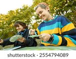 two young female artists conducting an outdoor painting lesson. Surrounded by nature, they are armed with easels, brushes, and a palette of colors, inspiring each other and their students.