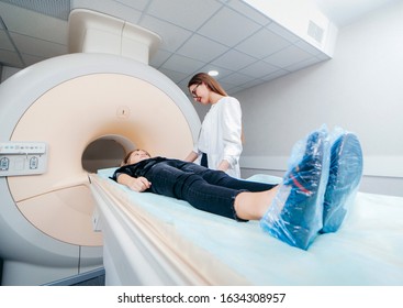 Two Young Female Doctors And Child In MRI Room 